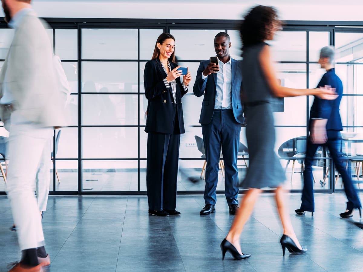 Business professionals in strategic planning meeting discussing long-term communication strategy